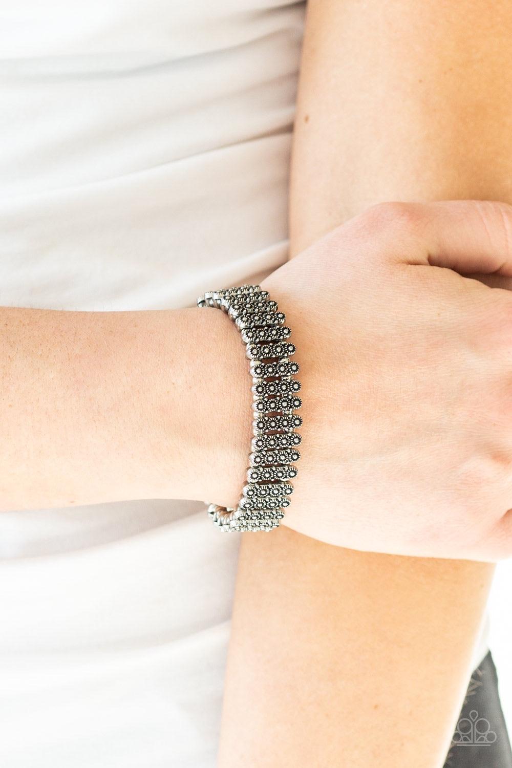 Paparazzi Accessories Rise With The Sun - Silver Dainty silver beads and stacked silver frames radiating with sunburst patterns are threaded along stretchy bands around the wrist for a whimsical look. Jewelry