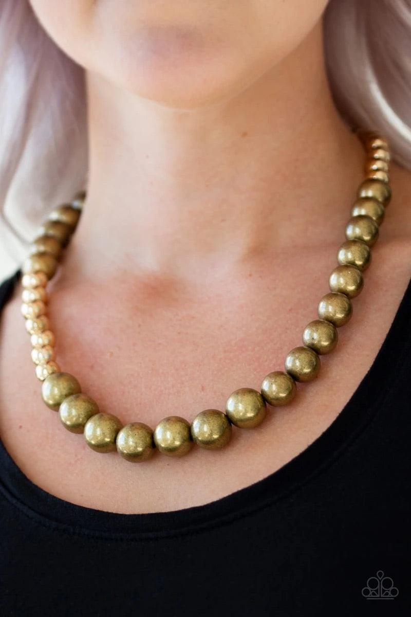 Paparazzi Accessories Power To The People - Brass Varying in size, glistening gold and antiqued brass beads drape below the collar in a dramatically asymmetrical fashion. Features an adjustable clasp closure. Sold as one individual necklace. Includes one