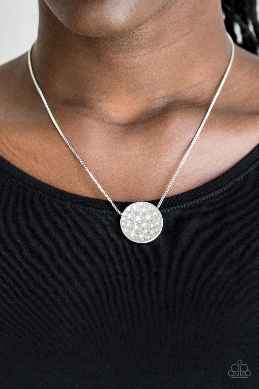 Paparazzi Accessories The BOLD Standard - Silver Delicately hammered in shimmery detail, a glistening silver pendant slides along a dainty silver box-chain below the collar for a bold look. Features an adjustable clasp closure. Sold as one individual neck