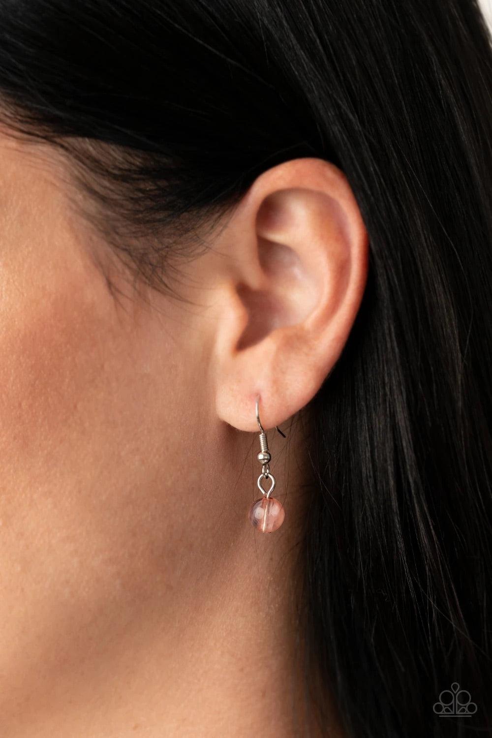 Paparazzi Accessories Seaside Solistice - Pink Featuring classic round and tranquil teardrop shapes, a glassy and opaque collection of Rose Tan, Peach Nougat, silver, and iridescent beads swing from a shimmery silver chain below the collar, creating an en