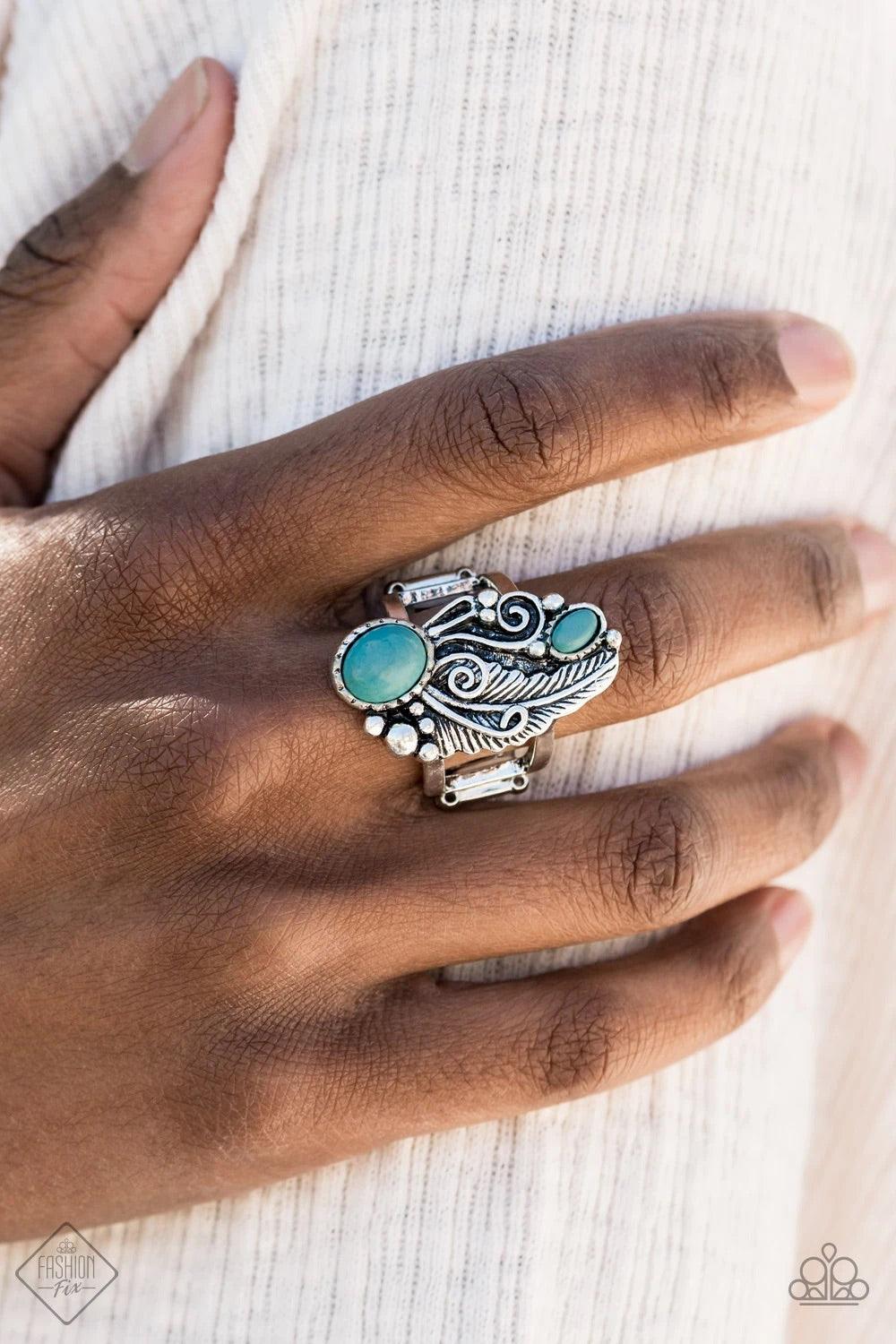 Paparazzi Accessories Desert Nest ~Blue Two oval turquoise stones are juxtaposed against a whimsical silver feather backdrop, creating a unique centerpiece atop the finger. Features a stretchy band for a flexible fit. Sold as one individual ring. Jewelry