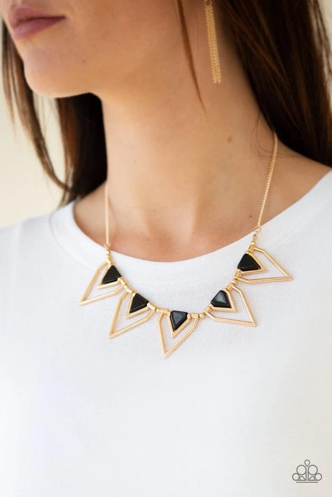 Paparazzi Accessories The Pack Leader - Gold Infused with shiny black beading, glistening gold triangular frames join below the collar, creating a fierce geometric fringe. Features an adjustable clasp closure. Sold as one individual necklace. Includes one