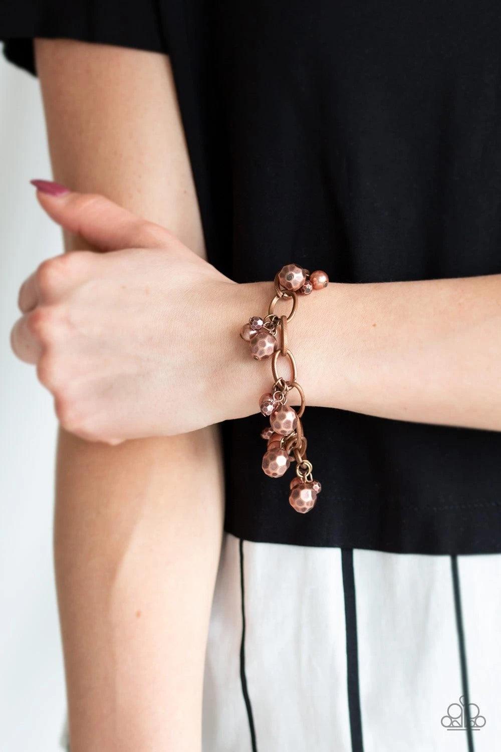 Paparazzi Accessories Make Do In Malibu - Copper Varying in size, a collection of faceted copper and pearly copper beads swings from a bold copper chain, creating a whimsical metallic fringe around the wrist. Features an adjustable clasp closure. Sold as