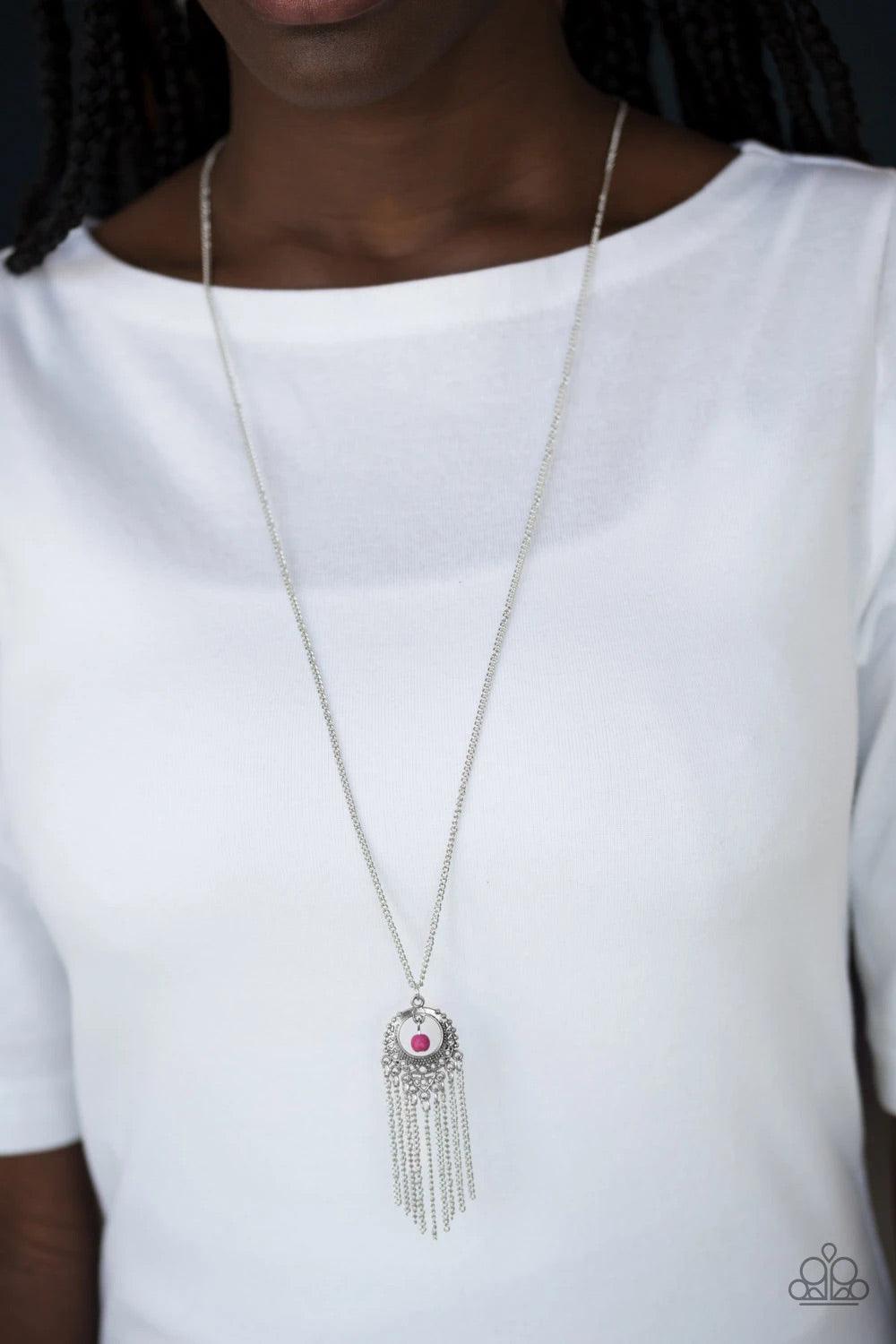 Paparazzi Accessories Western Weather - Pink A vivacious pink stone bead swings from the top of an ornate silver frame. Infused with a tapered tassel, the whimsical pendant swings from the bottom of an elongated silver chain for a wanderlust finish. Featu
