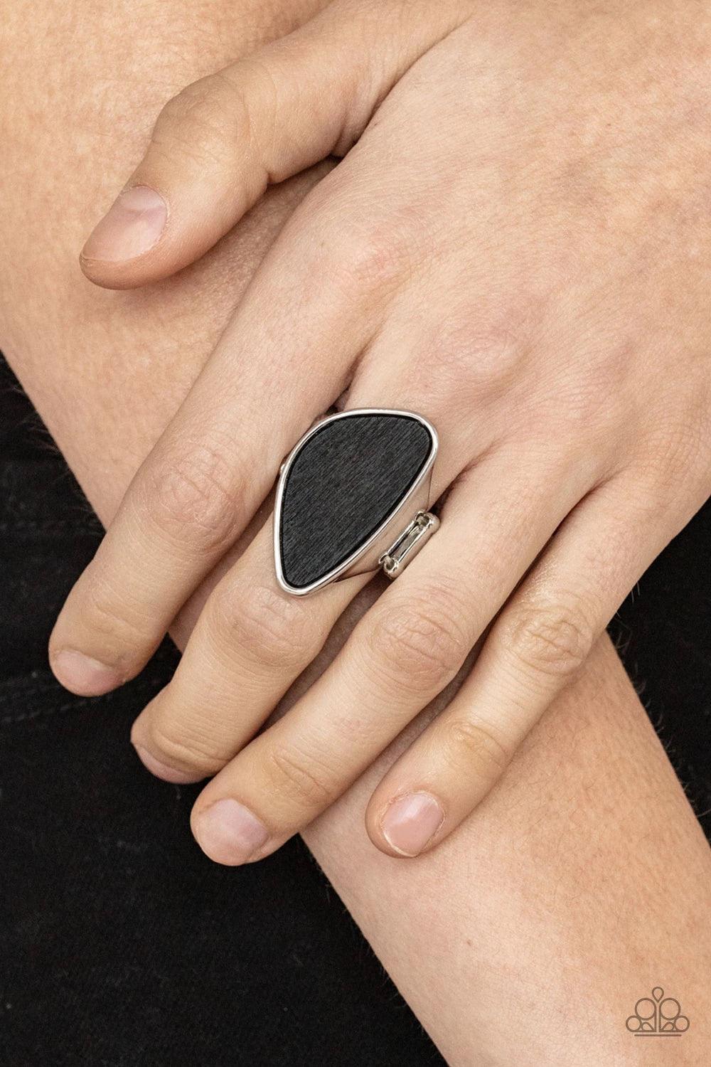Paparazzi Accessories Perfectly Petrified ~Black Rings an asymmetrical piece of rustic black wood is nestled inside a sleek silver frame that thickens into a shimmery band around the finger, creating a refined centerpiece. Features a stretchy band for a f