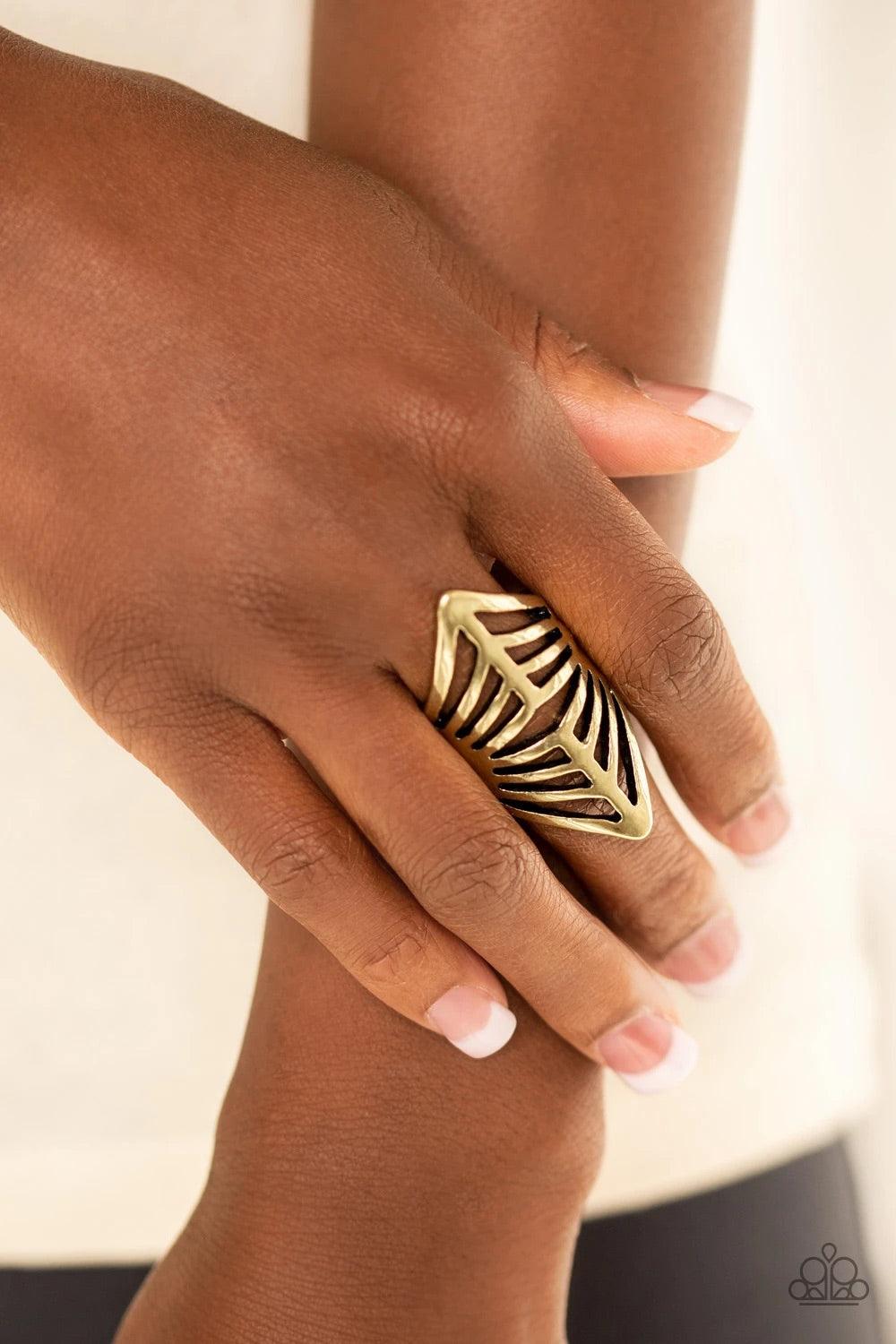 Paparazzi Accessories Deco Defender - Brass Glistening brass bars arc across the finger, coalescing into a bold centerpiece. Features a stretchy band for a flexible fit. Sold as one individual ring. Jewelry