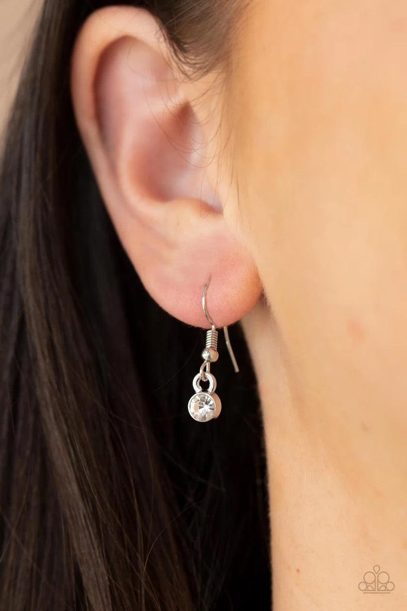 Paparazzi Accessories Undiluted Dazzle - Brown A raw cut topaz gem asymmetrically adorns the center of a warped white rhinestone oval frame, creating an extra sparkly pendant at the bottom of a classic silver frame. Features an adjustable clasp closure. S