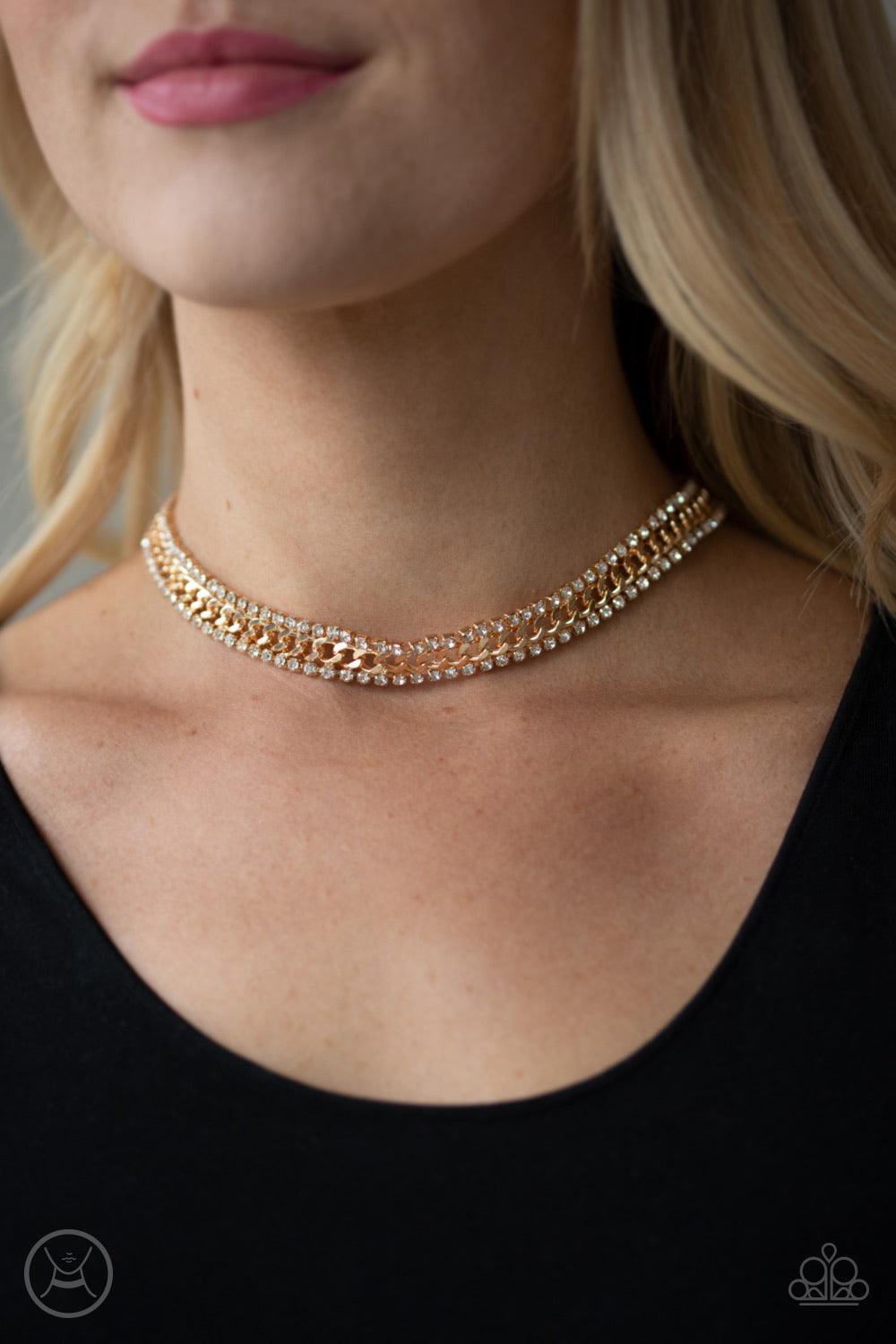 Paparazzi Accessories Empower-HER-Ment - Gold Featuring sleek square fittings, strands of glittery white rhinestones flank a glistening gold chain, coalescing into a regal look around the neck. Features an adjustable clasp closure. Jewelry
