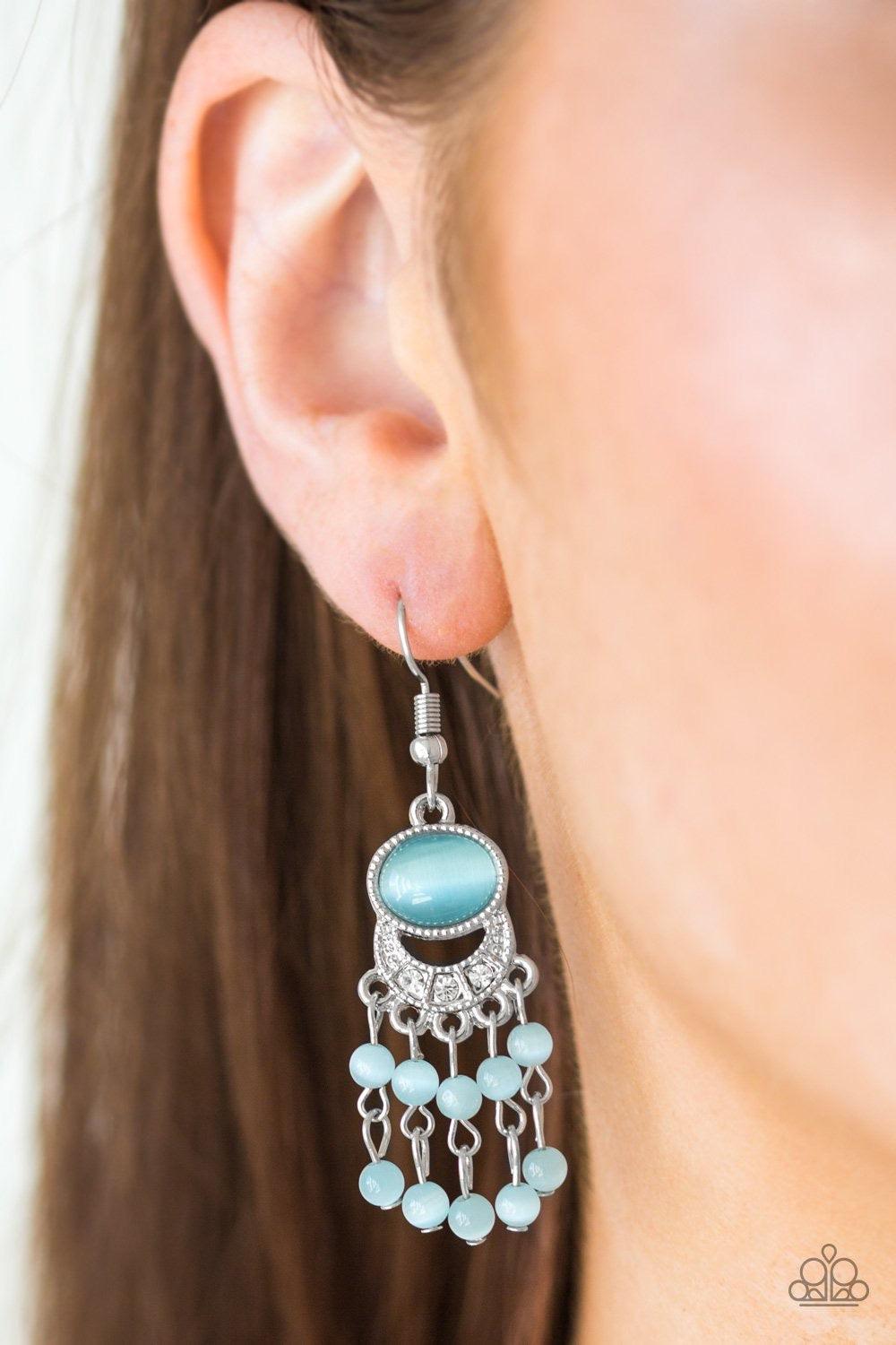 Paparazzi Accessories A Spring State Of Mind - Blue A glassy blue moonstone gives way to a bowing silver frame encrusted in dazzling white rhinestones. Stacks of dainty blue moonstone beading cascade from the bottom of the frame, creating a whimsical frin
