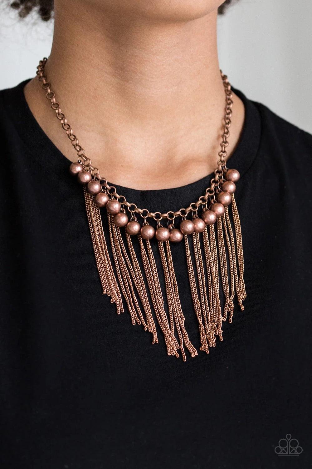 Paparazzi Accessories Powerhouse Prowl - Copper Glistening copper chains stream from the bottom of shimmery copper beads, creating an edgy industrial fringe below the collar. Features an adjustable clasp closure. Sold as one individual necklace. Includes