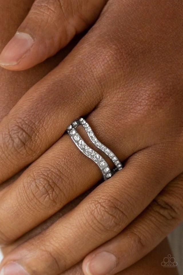 Paparazzi Accessories Elite Squad - White Varying in size, glittery white rhinestones are encrusted along waving silver bands for a refined look. Features a dainty stretchy band for a flexible fit. Rings