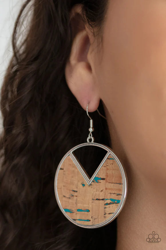 Paparazzi Accessories Nod To Nature - Blue Featuring hints of blue accents, an earthy piece of cork is placed into the center of a circular hoop. A triangular slice is removed from the cork, creating an edgy airy finish. Earring attaches to a standard fis