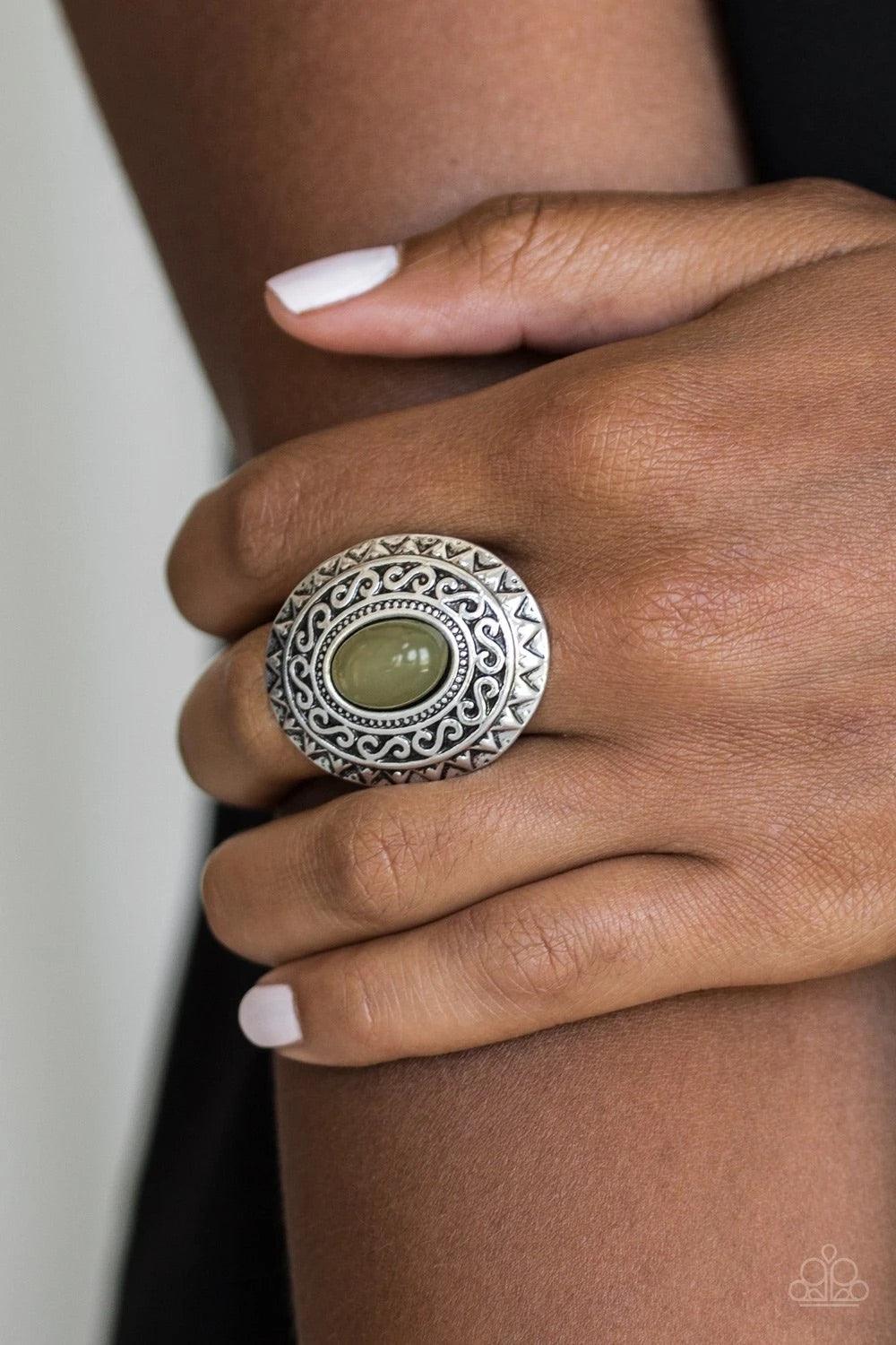 Paparazzi Accessories Hello, Sunshine - Green A glowing green stone is pressed in the center of a dramatic silver frame radiating with shimmery sunburst details for a seasonal look. Features a stretchy band for a flexible fit. Sold as one individual ring.