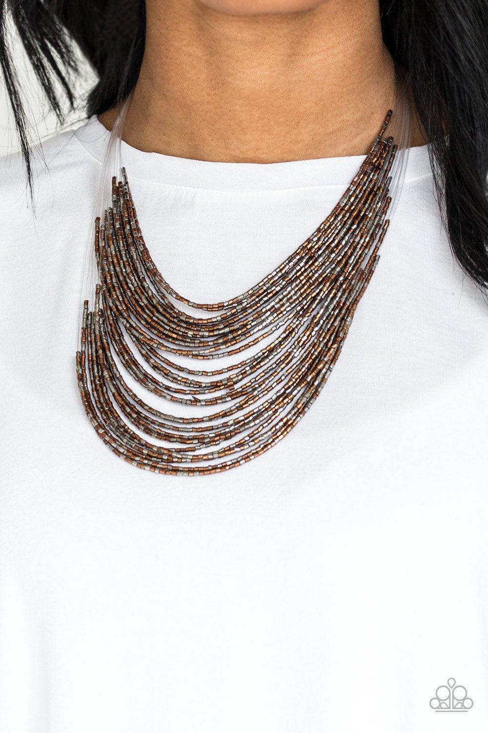 Paparazzi Accessories Catwalk Queen - Multi Strand after strand of metallic copper and gunmetal seed beads fall together to create a bold statement piece. Features an adjustable clasp closure. Sold as one individual necklace. Includes one pair of matching