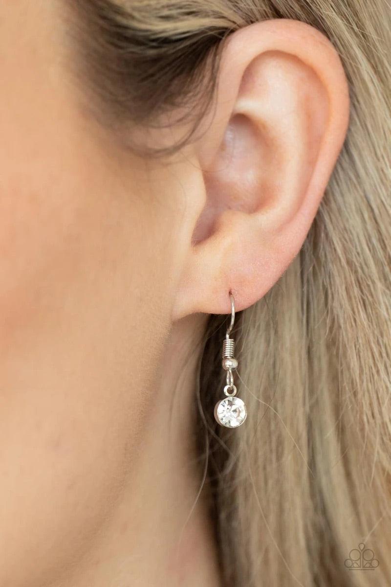 Paparazzi Accessories Instant Icon - White An oversized white gem is pressed into the center of a sleek silver fitting, creating a mesmerizing statement piece at the bottom of a sleek silver chain. Features an adjustable clasp closure. Sold as one individ