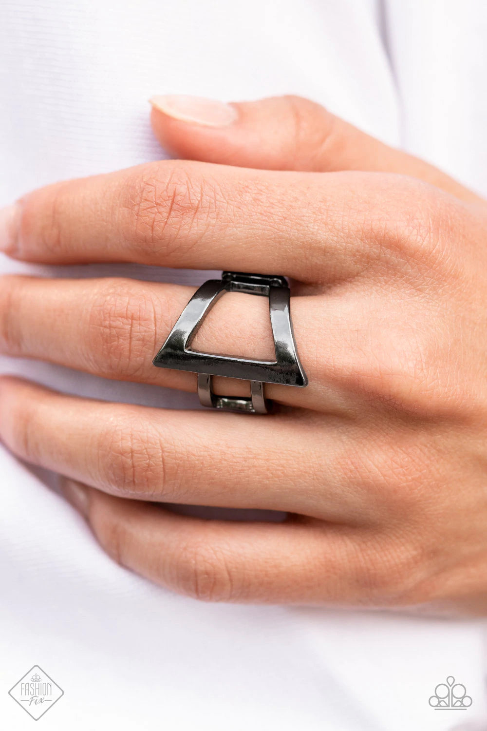 Paparazzi Accessories Rebel Edge - Black Featuring a high sheen finish, flared gunmetal bars create a bold asymmetrical triangle atop the finger. Two small gunmetal bars wrap around the side for an edgy modern finish. Features a stretchy band for a flexib