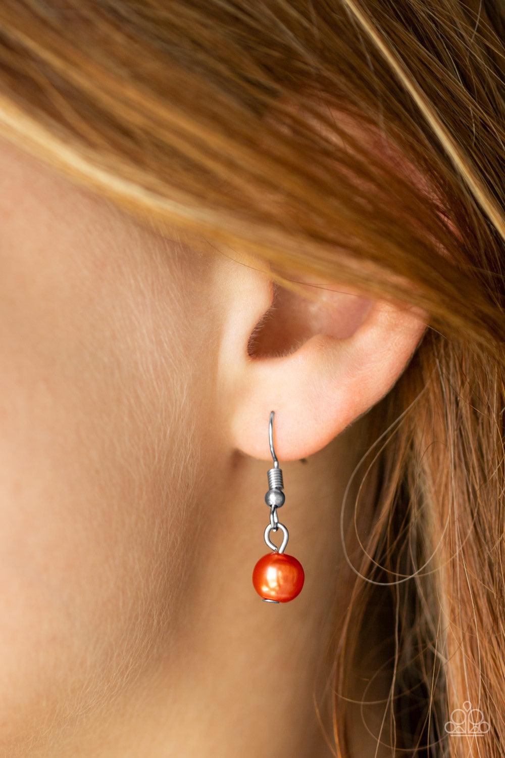 Paparazzi Accessories Put On Your Party Dress - Orange Pinched between white rhinestone encrusted frames, strands of classic orange pearls layer below the collar for a timeless look. Features an adjustable clasp closure. Jewelry