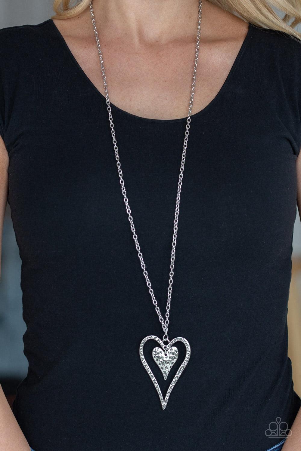 Paparazzi Accessories Hardened Hearts - Silver Hammered in glistening texture, mismatched silver heart frames swing from the bottom of a lengthened silver chain for a whimsical look. Features an adjustable clasp closure. Jewelry
