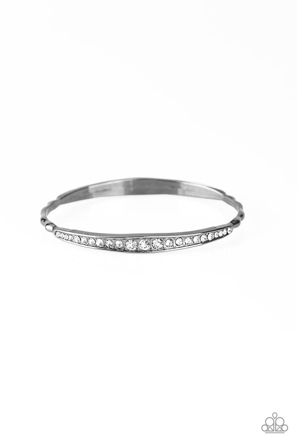 Paparazzi Accessories Just SPARKLE and Wave - Black Gradually increasing in size at the center, two sections of glassy white rhinestones are encrusted along a dainty gunmetal bangle rippling with wavy textures for a timeless twist. Jewelry