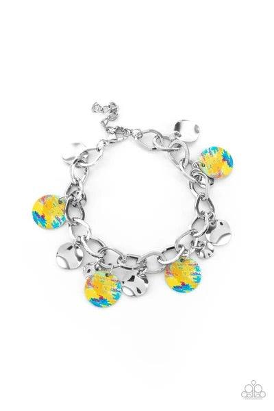 Paparazzi Accessories Teasingly Tie Die - Yellow Featuring a colorful tie dye print, a collection of colorful and dainty silver discs swings from a bulky silver chain around the wrist for a trendy finish. Features an adjustable clasp closure Jewelry