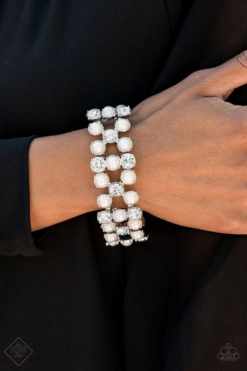 Paparazzi Accessories Diamonds and Debutantes - White Classic white pearls and brilliant white rhinestones are nestled into sleek silver frames and threaded along a stretchy band that wraps glamorously around the wrist. Jewelry