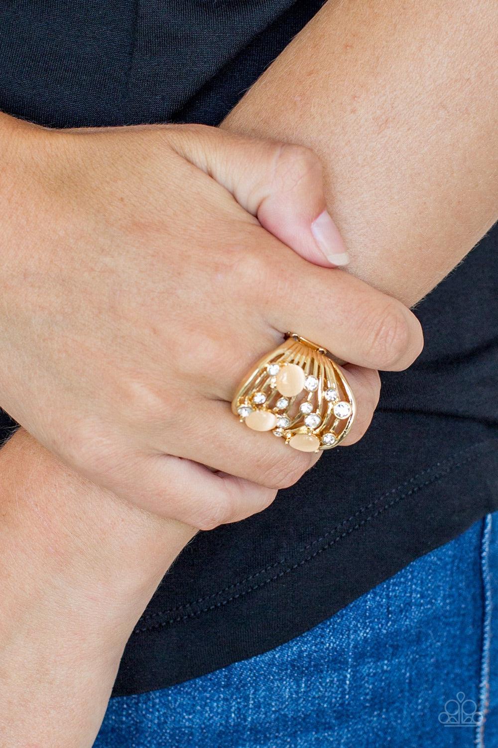 Paparazzi Accessories Clear The SWAY - Gold Glistening gold bars sway across the finger, coalescing into an airy band. Glittery white rhinestones and glowing moonstones are sprinkled along the wavy bands for a refined finish. Features a stretchy band for