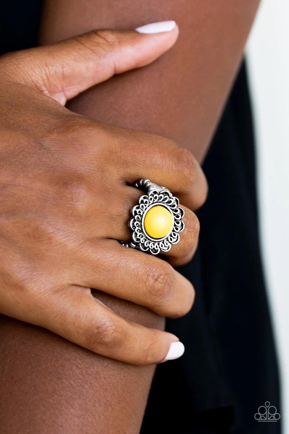 Paparazzi Accessories Garden Stroll - Yellow A sunny yellow bead is pressed into the center of a shimmery floral frame radiating with swirling detail. Features a stretchy band for a flexible fit. Sold as one individual ring. Jewelry
