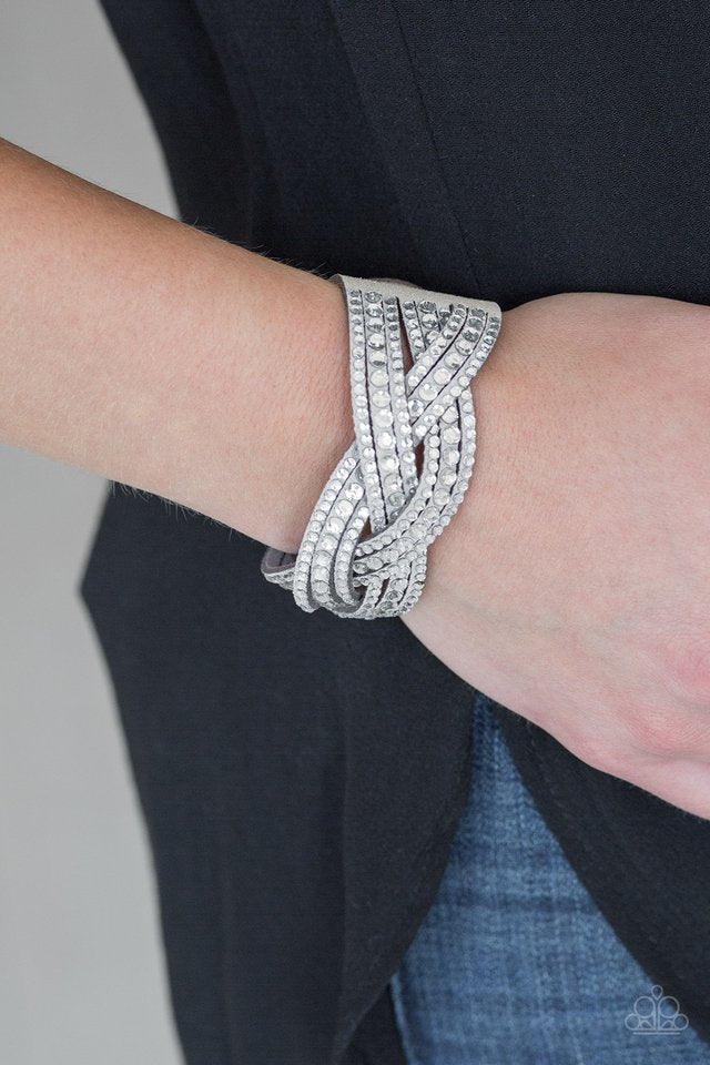 Paparazzi Accessories Bring on the Bling - Light Silver Varying in size, glassy white rhinestones are encrusted along interwoven gray suede bands, creating blinding shimmer across the wrist. Features an adjustable snap closure. Jewelry