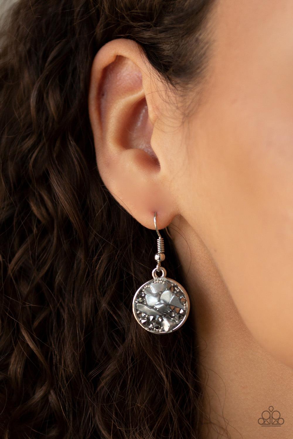 Paparazzi Accessories GLAM Crush Monday - Silver Infused with smoky and glassy rhinestone prisms, bits of metallic rock and dainty silver beads are sprinkled along the center of a round silver frame, creating a glittering pendant below the collar. Feature