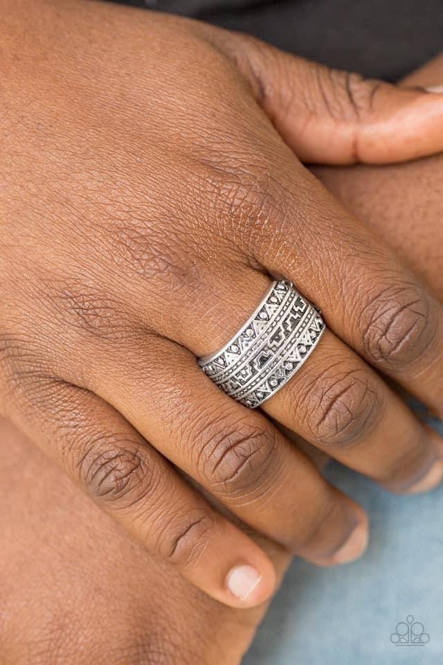 Paparazzi Accessories Textile Triumph - Silver Brushed in an antiqued shimmer, a glistening silver band is embossed in stunning textile patterns for a seasonal look. Features a stretchy band for a flexible fit. Sold as one individual ring. Jewelry