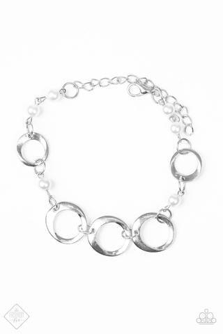 Paparazzi Accessories Poised And Polished - White Asymmetrical silver hoops connect with pearly white beads across the wrist for a refined look. Features an adjustable clasp closure. Jewelry