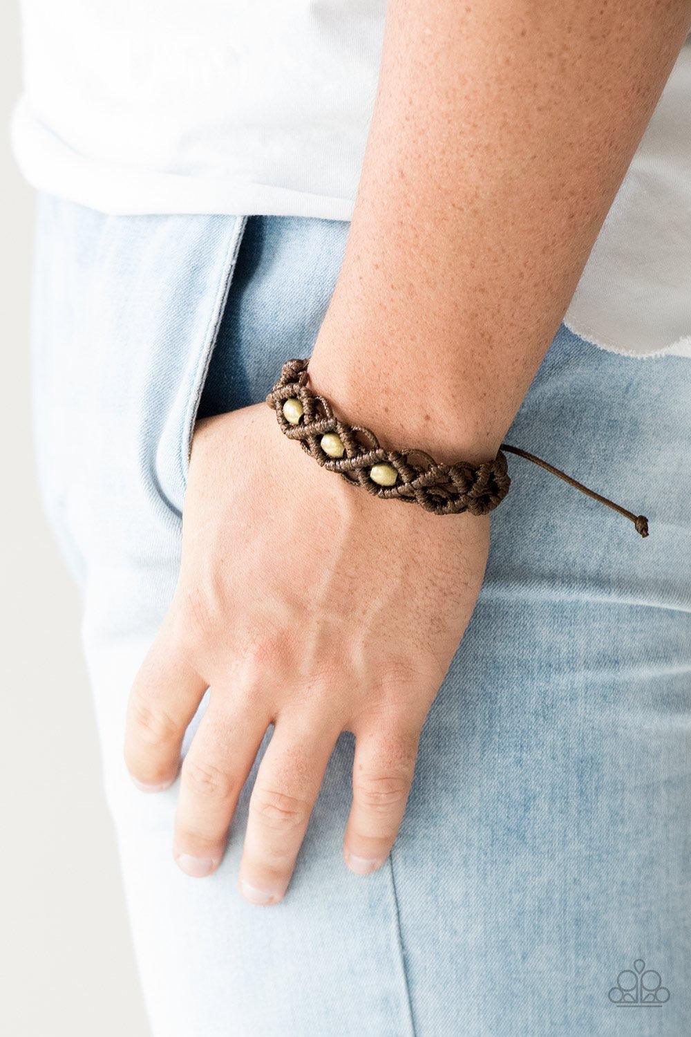 Paparazzi Accessories Nautical Navigator - Brown Brown twine and shiny brown cording knots around burnished brass beads, creating a netted pattern around the wrist. Features an adjustable sliding knot closure. Jewelry
