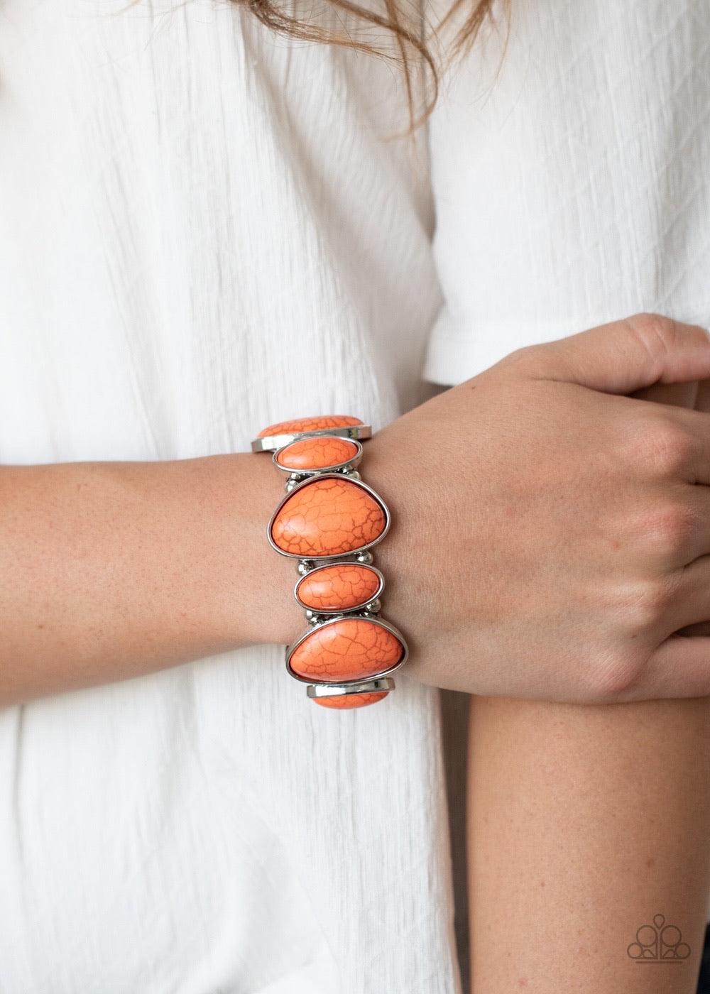 Paparazzi Accessories Feel At Homestead - Orange Featuring imperfect shapes, refreshing orange stones are pressed into asymmetrical silver frames that are threaded along stretchy bands that wrap around the wrist for an earthy look. Sold as one individual