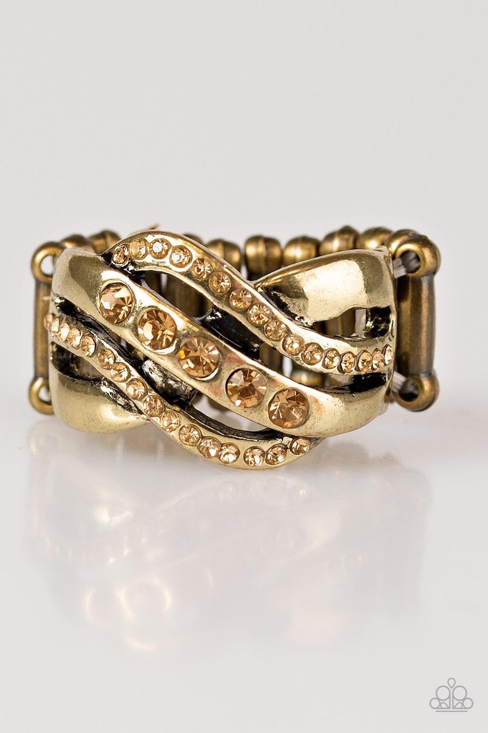 Paparazzi Accessories Flirting with Sparkle - Brass Shimmery brass bars swoop across the finger, creating an airy band. Complemented with dainty topaz rhinestones, the centermost brass band is encrusted in slightly larger glittery topaz rhinestones for a