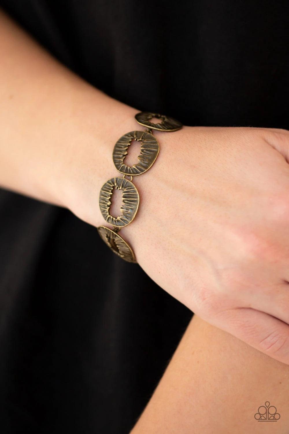 Paparazzi Accessories Cut It Out! - Brass Featuring asymmetrical cutout centers, textured brass discs connect across the wrist for an abstract look. Features an adjustable clasp closure. Sold as one individual bracelet. Jewelry