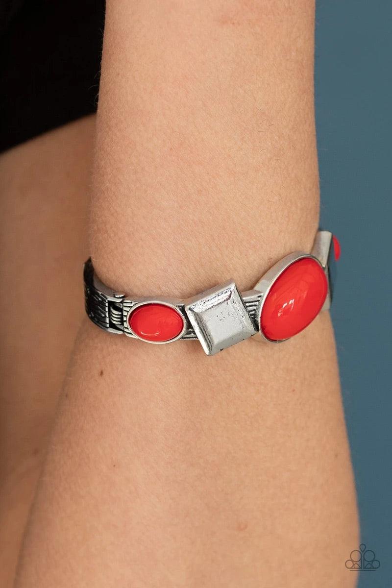 Paparazzi Accessories Abstract Appeal - Red Fiery red oval beads and antiqued silver square frames are pressed into the textured front of a cuff-like bangle, creating a colorful pop of color around the wrist. Features a hinged closure. Sold as one individ