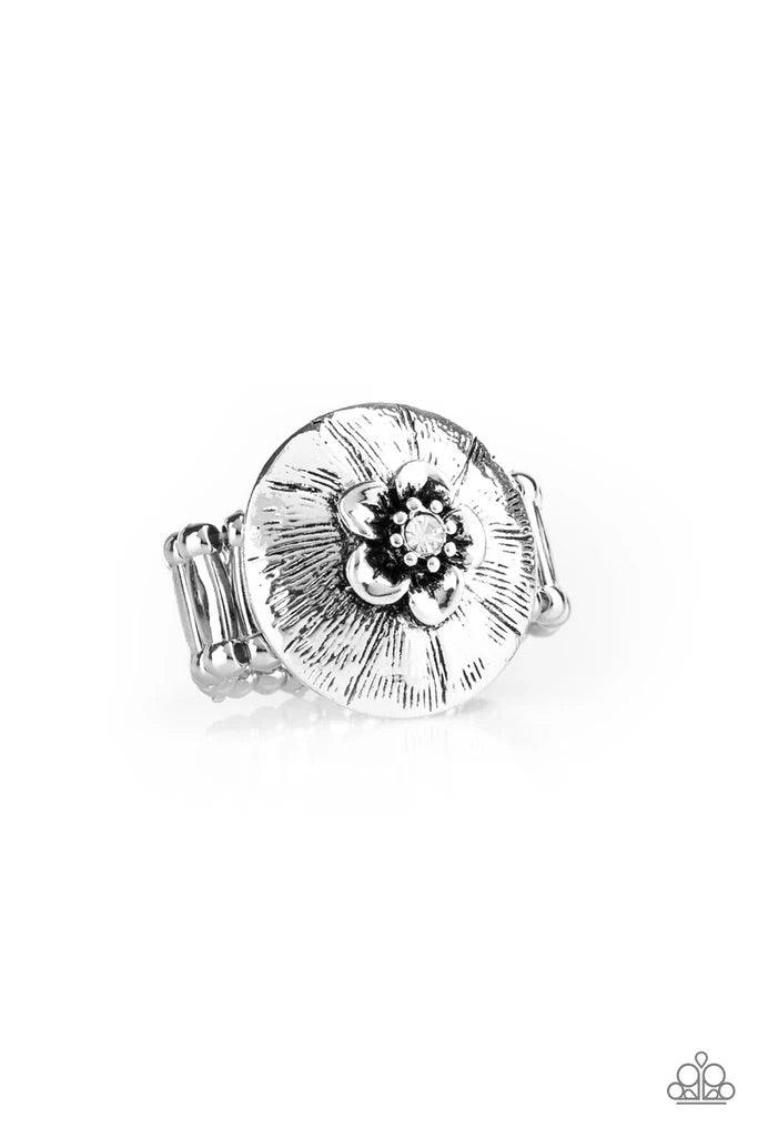 Paparazzi Accessories Blooming Beach Party - White Dotted with a sparkling white rhinestone, a dainty silver flower blooms atop a rounded frame radiating with shimmery silver texture for a seasonal look. Features a stretchy band for a flexible fit. Sold a