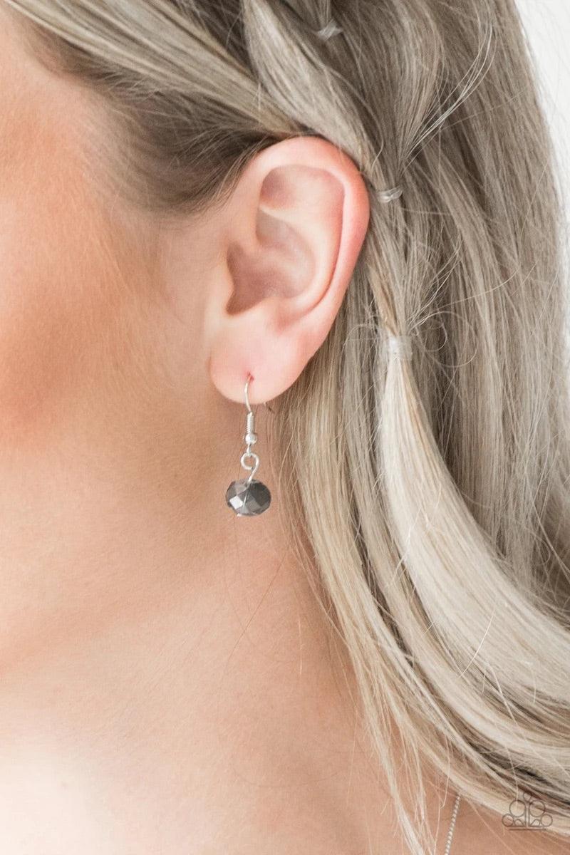 Paparazzi Accessories Champagne On The Rocks - Silver Infused with dainty silver accents, metallic and smoky crystal-like beads trickle along a dainty silver chain across the chest for a refined look. Features an adjustable clasp closure.Sold as one indiv