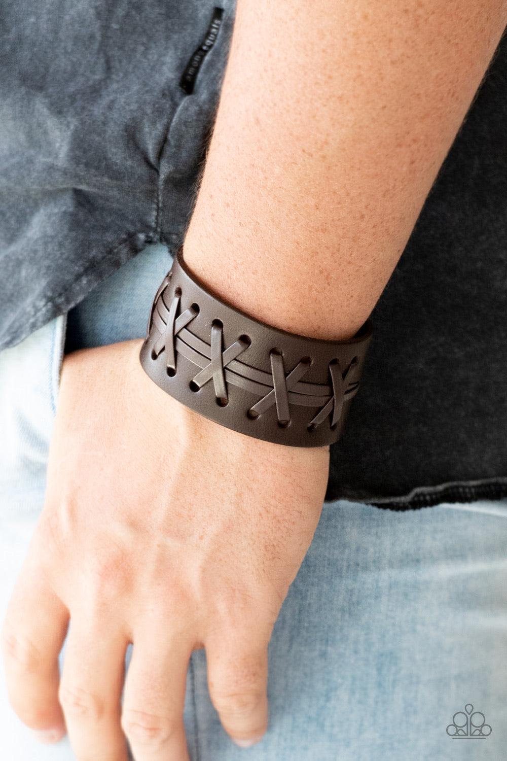 Paparazzi Accessories Super Sporty - Brown Brown leather cording is laced across the front of a thick leather band for a rugged look. Features an adjustable snap closure. Sold as one individual bracelet. Jewelry