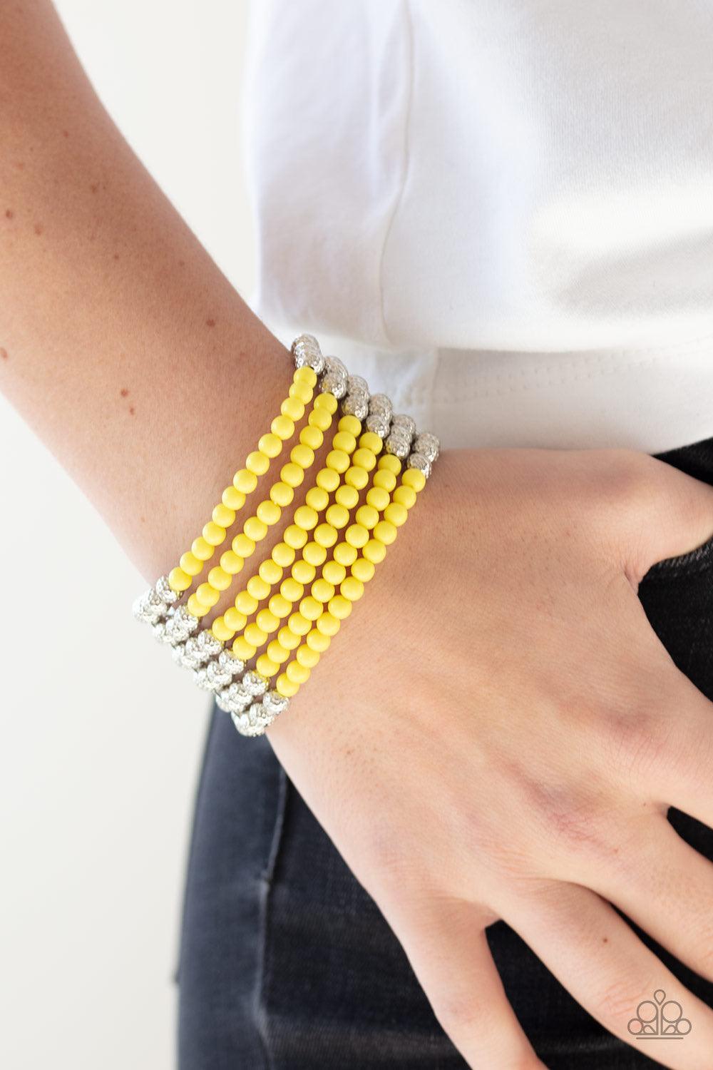 Paparazzi Accessories LAYER It on Thick - Yellow Held together with silver fittings, row after row of ornate silver and polished yellow beads are threaded along stretchy bands around the wrist for a colorful fashion. Jewelry