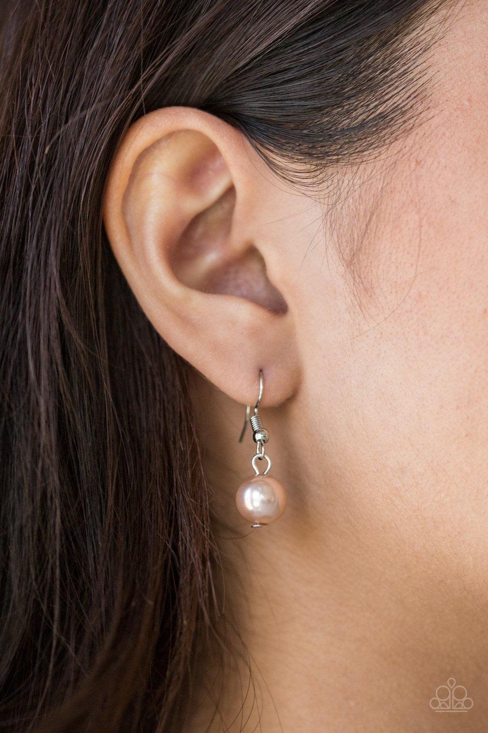 Paparazzi Accessories Classical Cadence - Brown Wrapped in wire mesh, classic silver beads join pearly brown beads along a shimmery silver chain. Varying in size and shimmer, mismatched silver chains layer behind the beaded strand for a refined finish. Fe