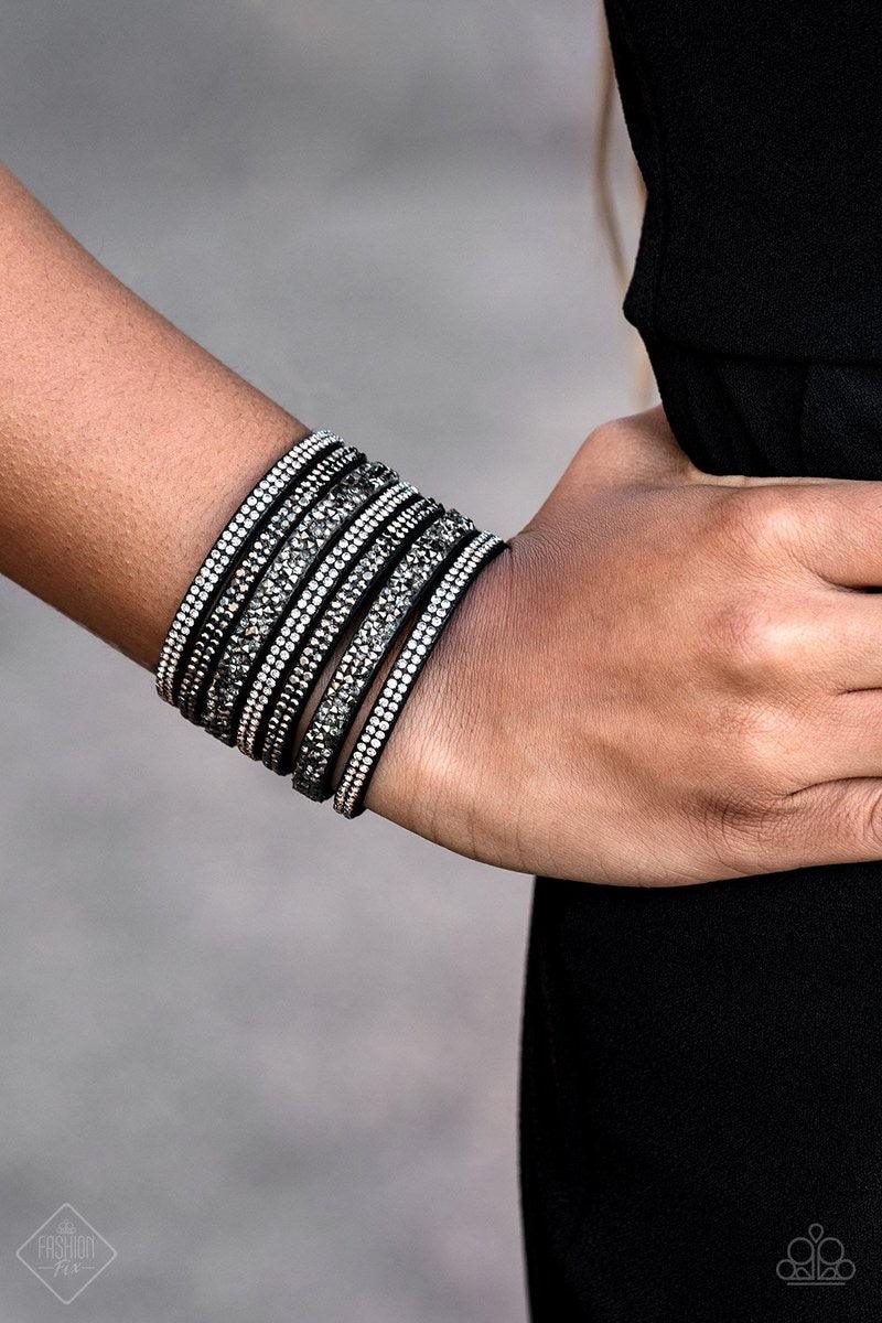 Paparazzi Accessories Rebellious Shine - Black Featuring classic round and edgy prism style cuts, row after row of smoky and hematite rhinestones stack across the wrist for a sassy look. Features an adjustable snap closure. Jewelry