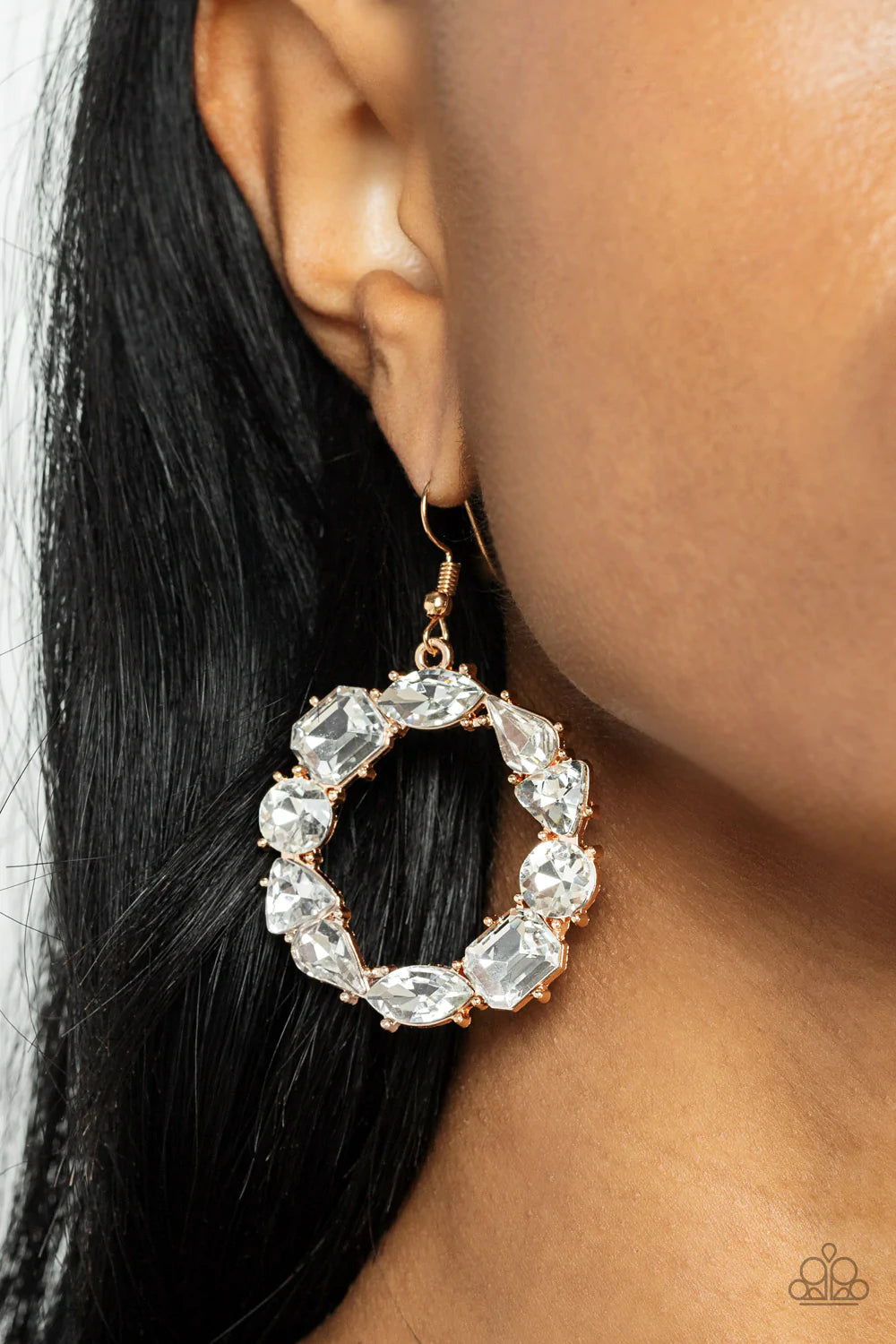 Paparazzi Accessories GLOWING in Circles - Gold Featuring glistening gold fittings, a regal assortment of round, triangular, teardrop, marquise, and emerald cut white rhinestones delicately coalesce into a jaw-dropping hoop. Earring attaches to a standard