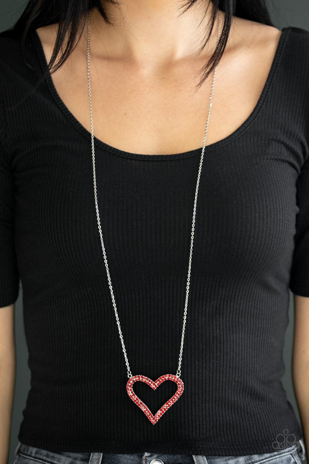 Paparazzi Accessories Pull Some HEART-strings - Red Two rows of glittery red rhinestones stack into a sparkling heart pendant at the bottom of a lengthened silver chain for a heart-stopping look. Features an adjustable clasp closure. Jewelry