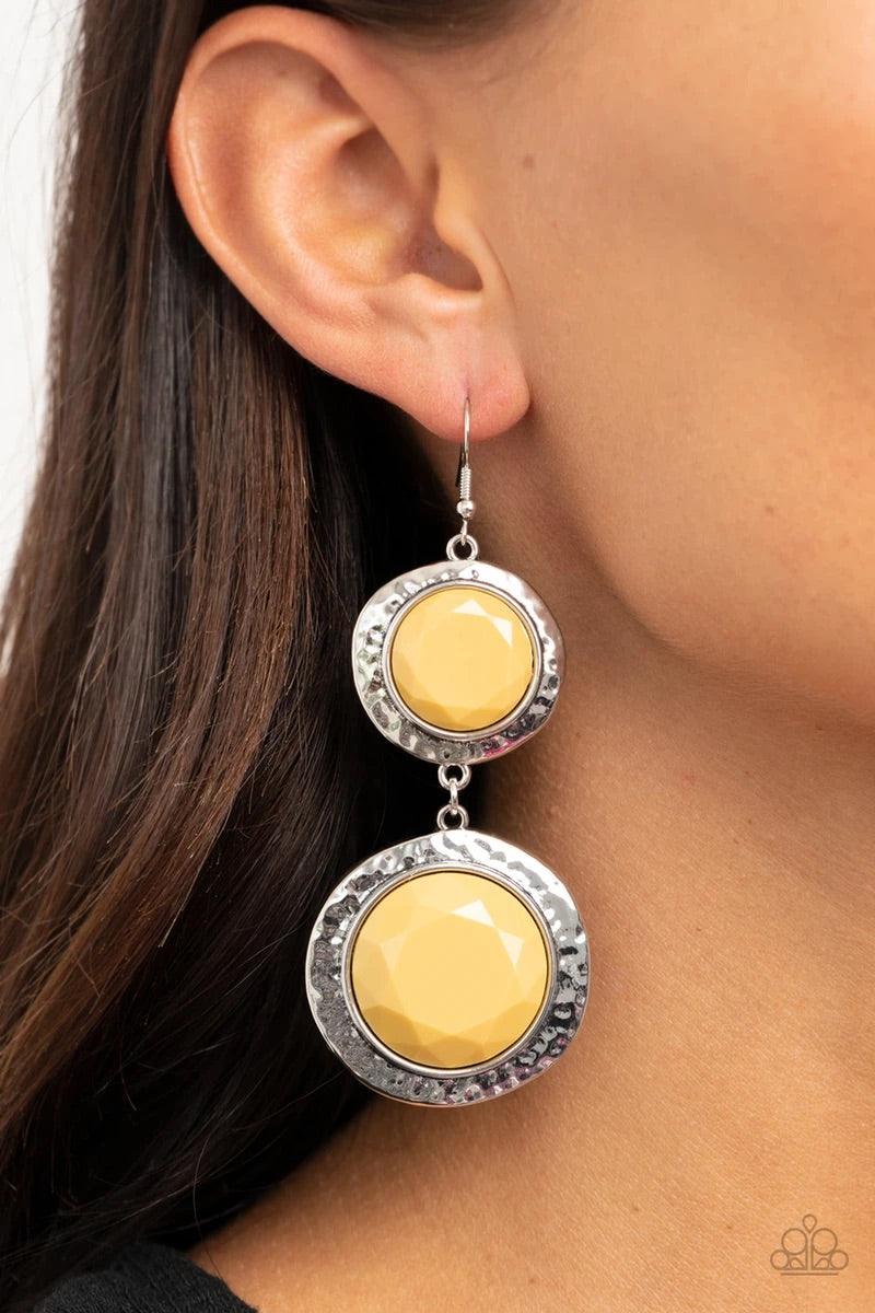 Paparazzi Accessories Thrift Shop Stop - Yellow Varying in size, a pair of faceted yellow beads are pressed into the shimmery centers of hammered silver frames as they link into a colorfully rustic lure. Earring attaches to a standard fishhook fitting. So