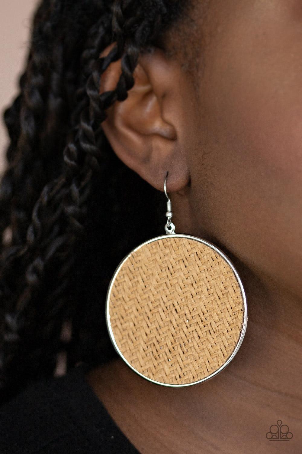 Paparazzi Accessories Wonderfully Woven - Brown Brown twine-like cording weaves across the front of an oversized silver disc for an earthy flair. Earring attaches to a standard fishhook fitting. Sold as one pair of earrings. Jewelry