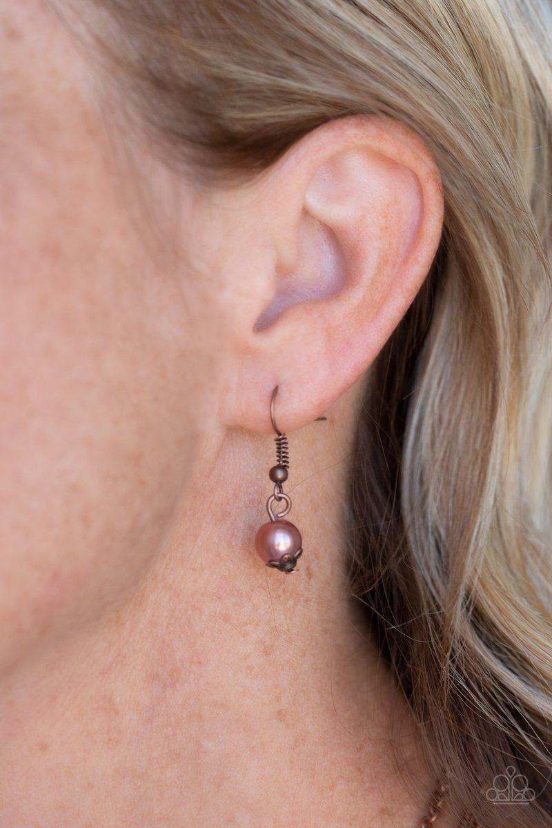 Paparazzi Accessories Tour de Demure - Copper Infused with two layers of dainty copper chains, pearly copper beads and coppery aurum rhinestones link below the collar for a demure look. Features an adjustable clasp closure. Sold as one individual necklace