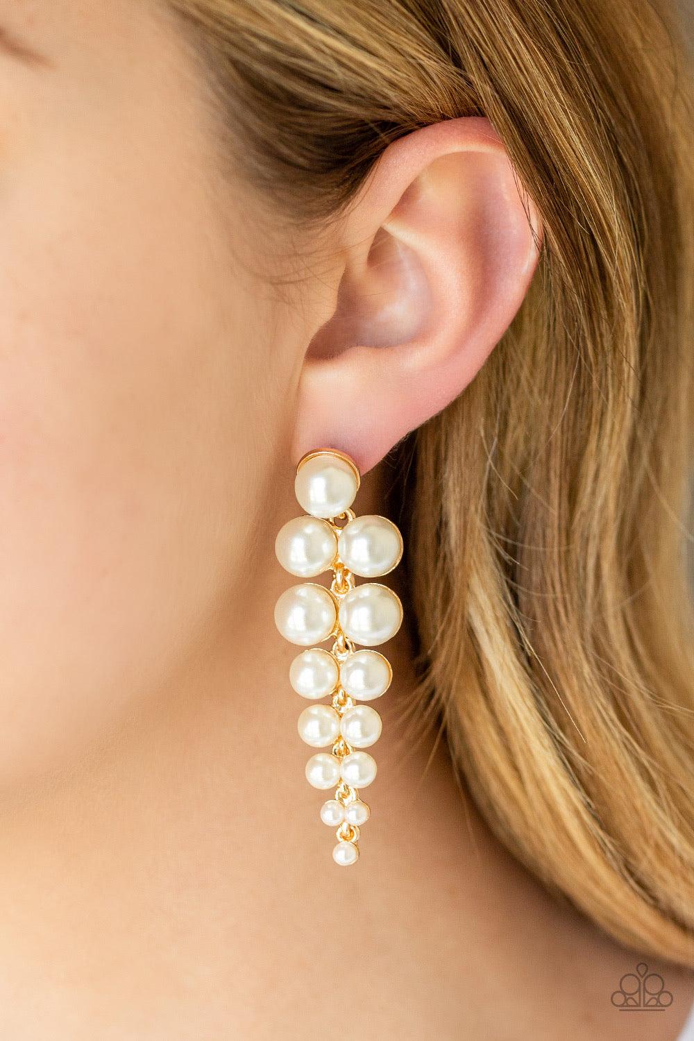 Paparazzi Accessories Totally Tribeca - Gold Gradually decreasing in size, pairs of classic white pearls drip from a solitaire pearl, coalescing into a dramatic triangular-shaped lure. Earring attaches to a standard post fitting. Jewelry
