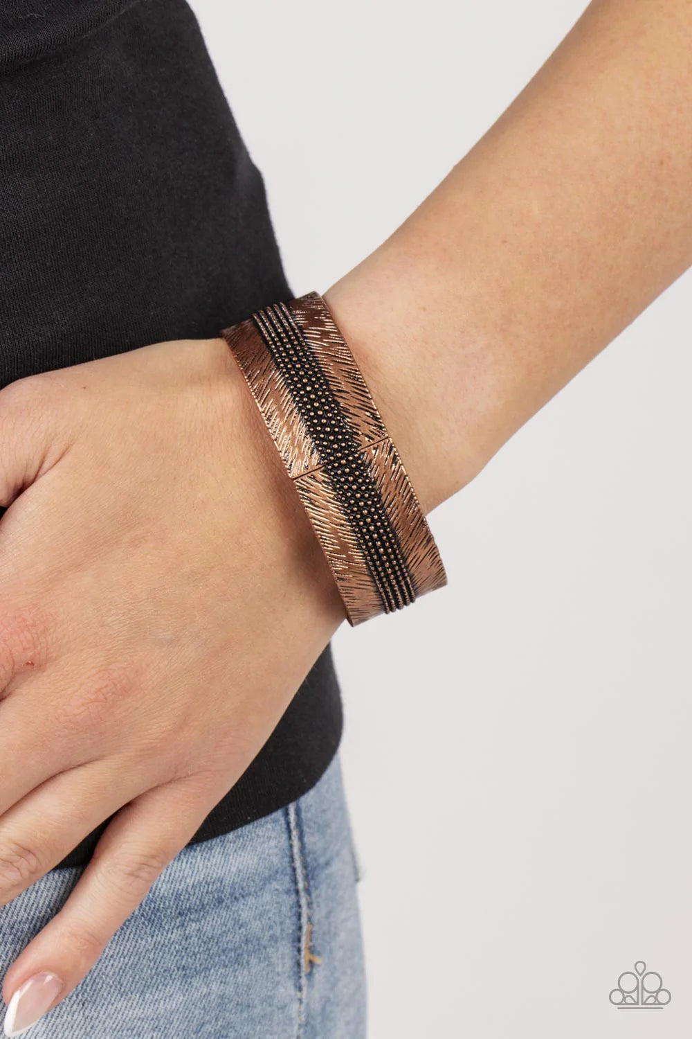 Paparazzi Accessories Rancho Refinement - Copper A thick band of copper is etched in feathery texture, creating a tactile statement piece that boldly wraps around the wrist. Rows of antiqued copper studs travel around the center of the thick copper band,