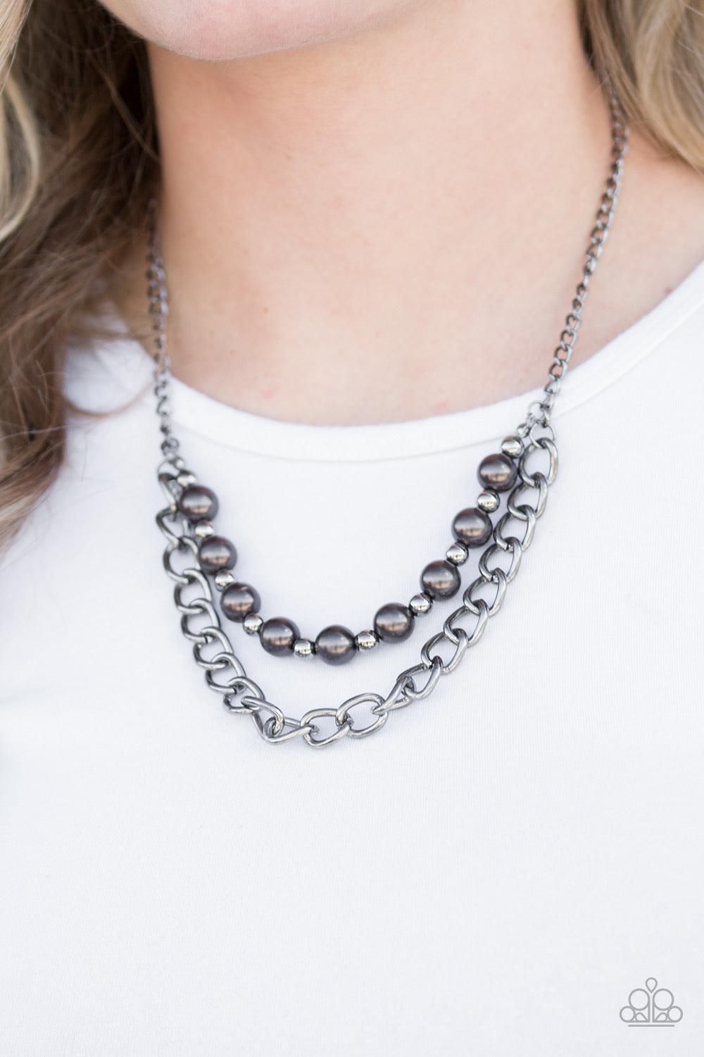 Paparazzi Accessories Glam And Grind - Black Pearly gunmetal and glistening gunmetal beads are threaded along a skinny wire. The pearly beading gives way to a bold strand of gunmetal chain, creating edgy layers below the collar. Features an adjustable cla